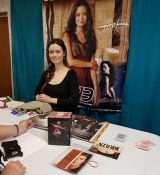 Lovely photo of Summer signing Firefly items at her booth.